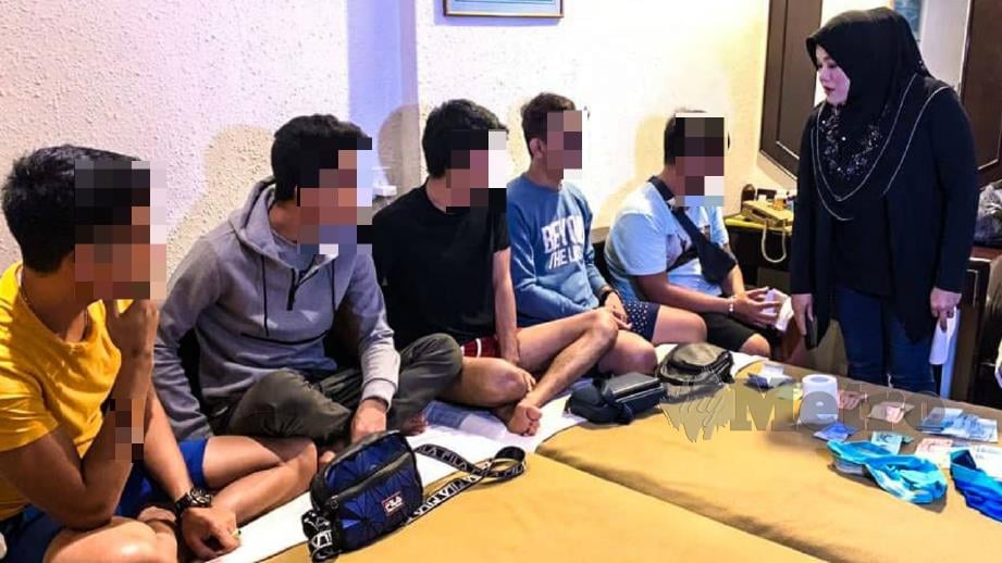 Kholijah (kanan) menyoal lima lelaki yang ditahan dalam sebuah bilik hotel. FOTO Ihsan Pembaca