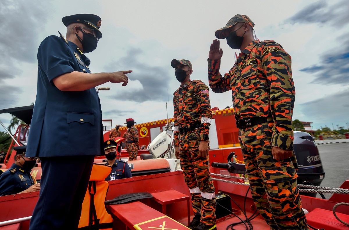 Mohammad Hamdan (kiri) bertanyakan sesuatu kepada anggota bomba ketika meninjau persiapan kesiapsiagaan banjir Jabatan Bomba dan Penyelamat Sarawak hari ini. FOTO BERNAMA