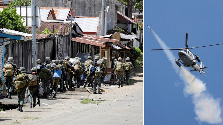 Tentera marin Filipina memasuki bandar Marawi, memeriksa dari rumah ke rumah ketika pertempuran masih berlangsung. Tentera Filipina juga melakukan pengeboman dari udara di kawasna tertentu  - Foto REUTERS