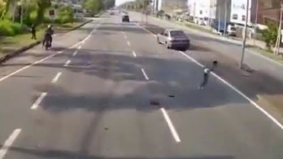 TANGKAP layar video tular menunjukkan seorang budak lelaki nyaris digilis kenderaan kerana dikejar anjing. 