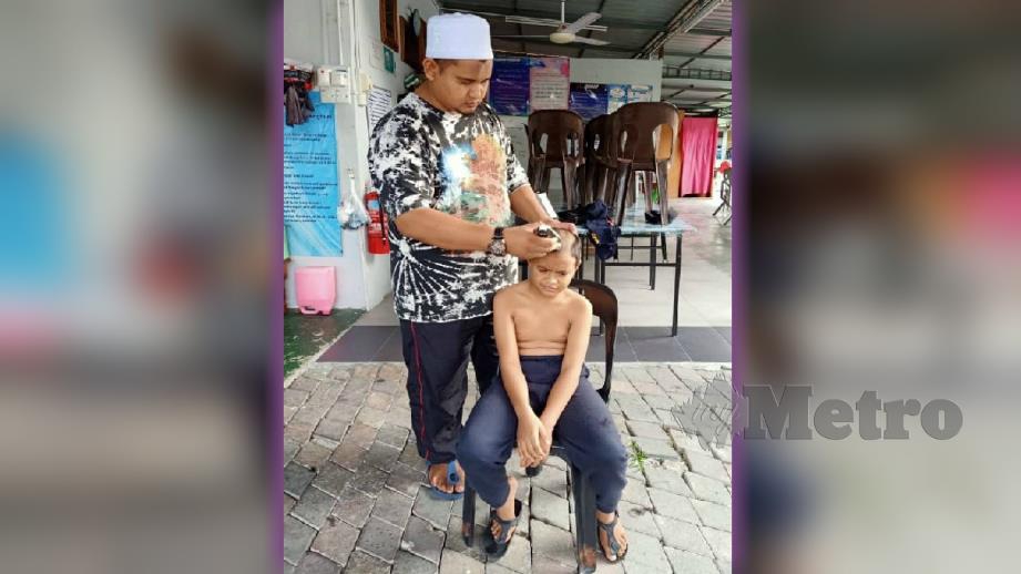 MOHD Zatullah menggunting sendiri rambut anak yatim di bawah jagaannya. FOTO Mohd Amin Jalil.