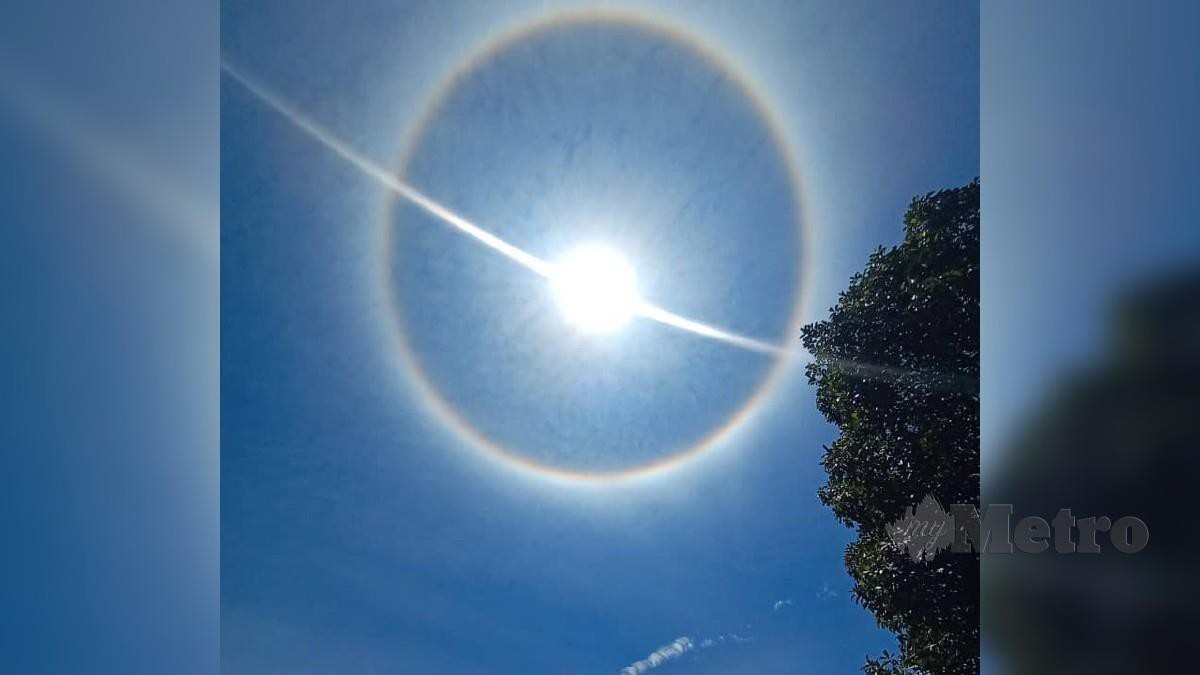 Lingkaran cahaya berbentuk cincin akibat fenomena Halo yang sempat dirakam ketika berlaku hari ini. Foto Ihsan Pembaca  