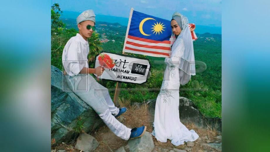 MOHD Zizi bersama Nabila Akma bergambar di puncak Bukit Harimau Menangis. FOTO ihsan pembaca