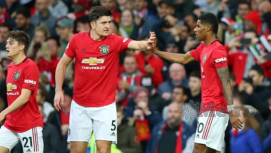 Maguire dan Rashford (kanan) meraikan jaringan United. FOTO Agensi 