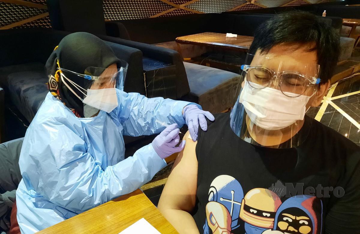 Seorang lelaki menerima vaksin Covid-19 di Jakarta, Indonesia. - FOTO EPA