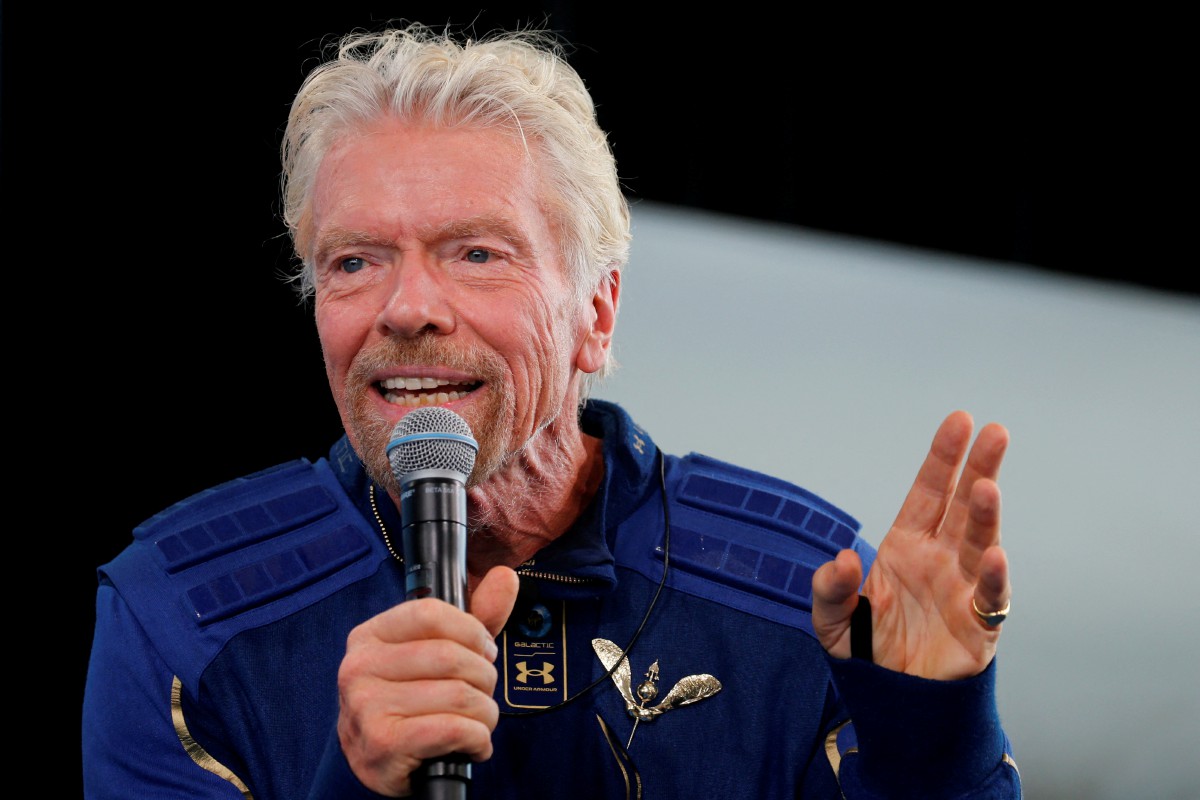 FILE PHOTO: Billionaire entrepreneur Richard Branson wears his astronaut's wings at a news conference, after flying with a crew in Virgin Galactic's passenger rocket plane VSS Unity to the edge of space at Spaceport America near Truth or Consequences, New Mexico, U.S., July 11, 2021. REUTERS/Joe Skipper/File Photo