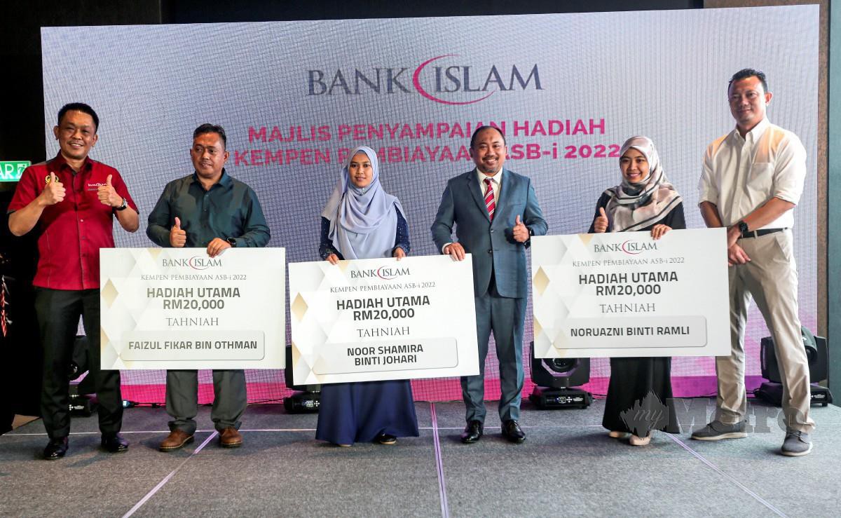 Ketua Pegawai Perniagaan Kumpulan Runcit Bank Islam Malaysia Berhad, Mizan Masram (tiga dari kanan) bersama pemenang hadiah utama pada majlis penyampaian hadiah kempen pembiayaan ASB-i Bank Islam. - FOTO NSTP
