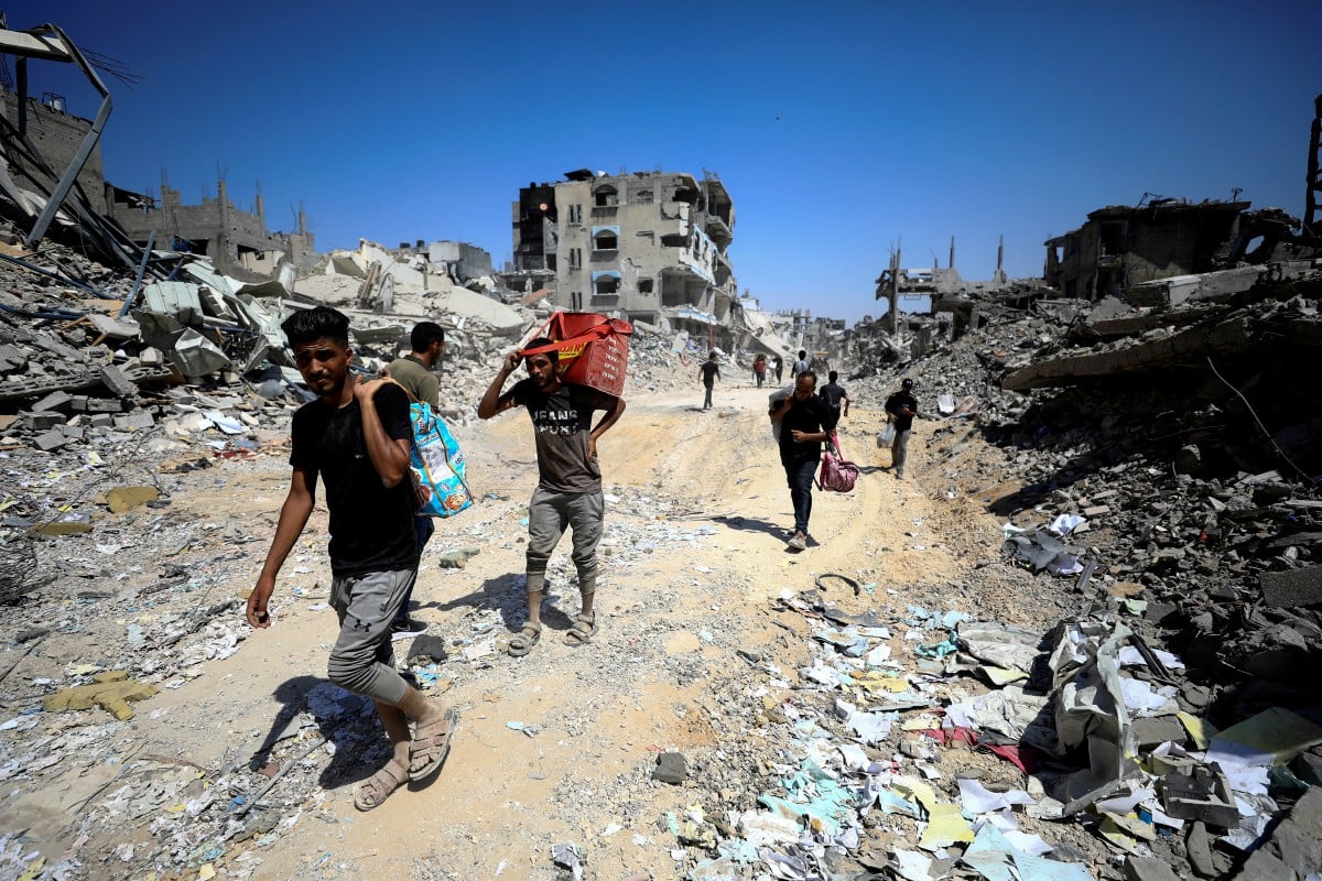 Penduduk Palestin berjalan sambil memeriksa kerosakan, selepas tentera Israel berundur dari kawasan kejiranan Shejaiya di bahagian timur Bandar Gaza pada 10 Julai 2024. FOTO REUTERS/Dawoud Abu Alkas 