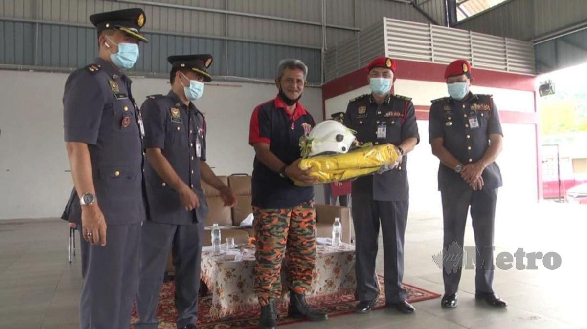 PENGARAH JBPM Pahang, Wan Mohammad Zaidi Wan Isa menyampaikan peralatan  kepada Pasukan Bomba Sukarela (PBS) Rumpun Makmur hari ini. FOTO Roselan Ab Malek