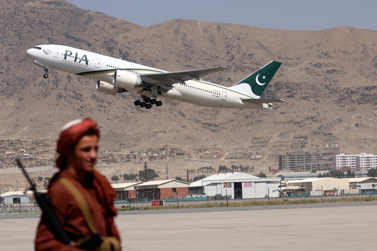 Seorang pejuang Taliban mengawal lapangan terbang ketika pesawat PIA berlepas dari Kabul. - FOTO AFP