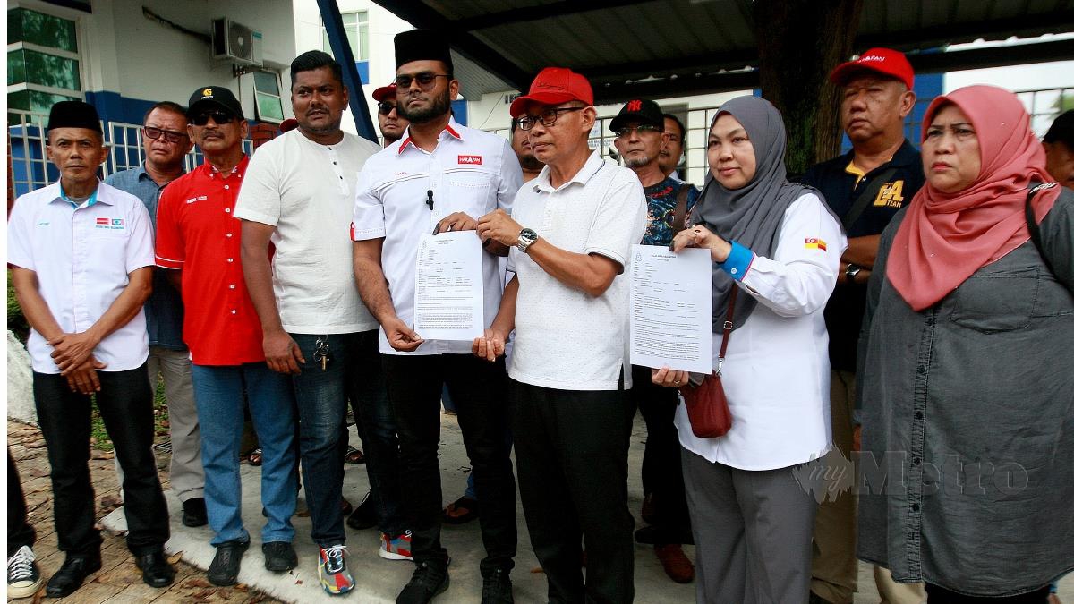 Shaari Abdul Malik (empat dari kanan) bersama Jentera Pilihan Raya Pakatan Harapan (PH) Dewan Undangan Negeri (ADUN) N.49 Sungai Kandis, Mohd Zawawi Ahmad Mughni tampil membuat laporan polis di Ibu Pejabat Polis Daerah (IPD) Shah Alam. FOTO AIZ ANUAR