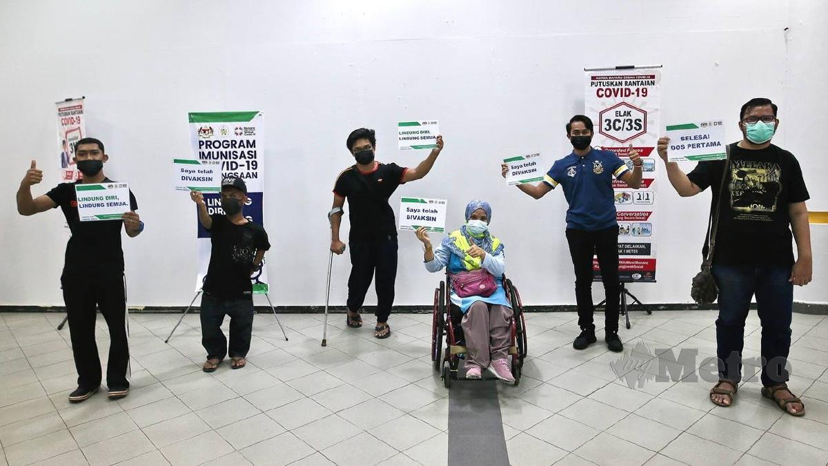 NORHASLINA (tengah) yang hadir menerima suntikan Vaksin COVID19 dos pertama di Pusat Dagangan Terengganu (TTC). FOTO Ghazali Kori