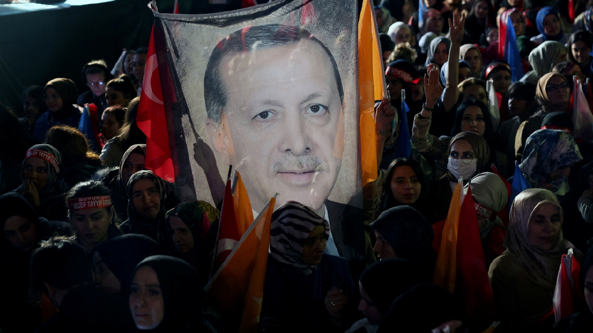 PENYOKONG memegang bendera yang mempunyai wajah Erdogan FOTO AFP