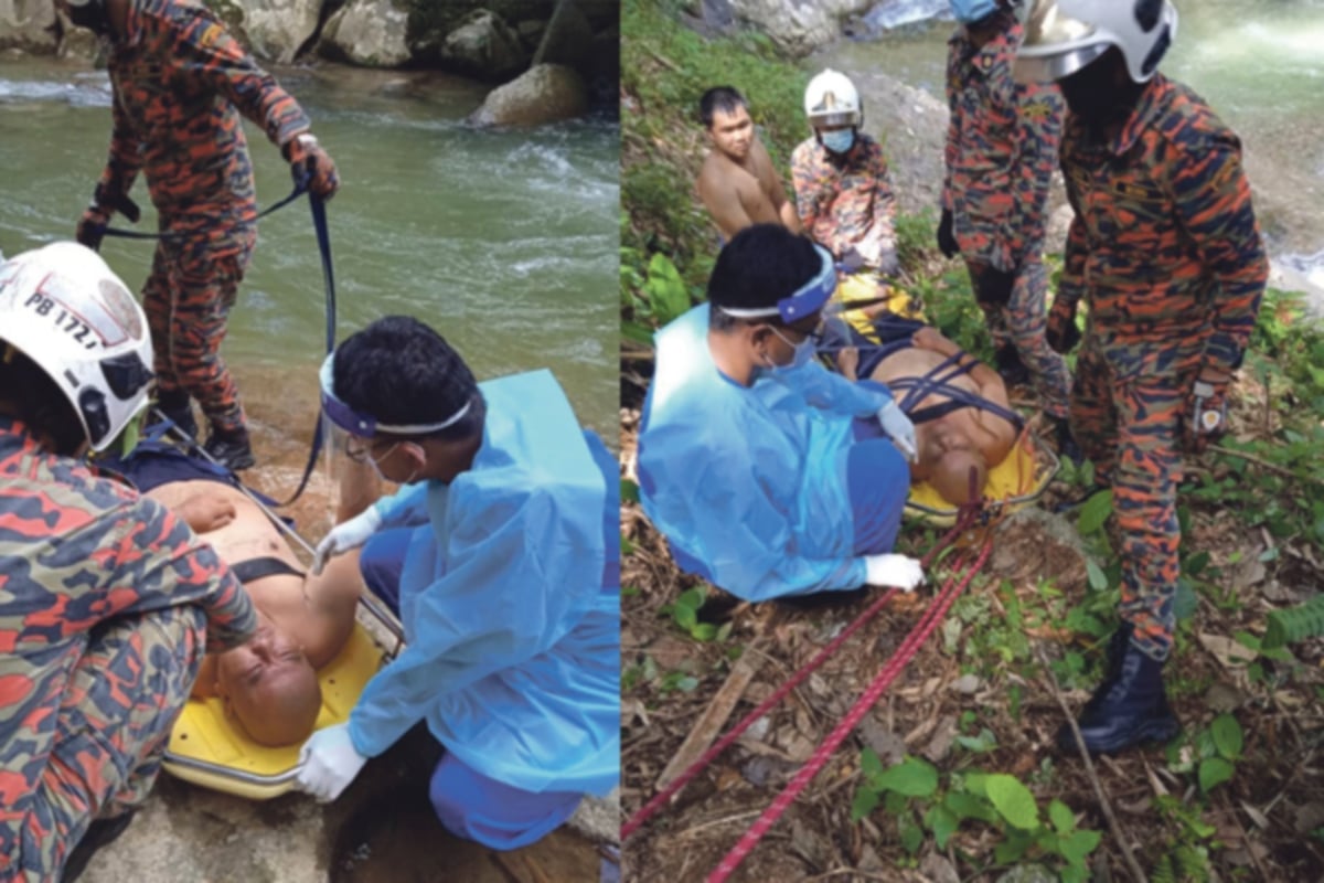 ANGGOTA bomba menyelamatkan seorang lelaki yang cedera pada bahu selepas terjatuh di atas batu ketika mandi di tebing Sungai Kedondong, Jalan Batang Kali, hari ini. FOTO ihsan Bomba