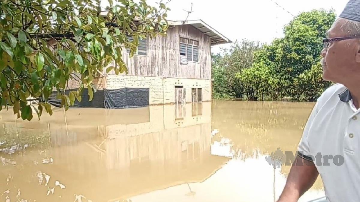 Che Daud melihat rumahnya yang ditenggelami air di Kampung Kempas, Mak Bakas. FOTO ZAID SALIM