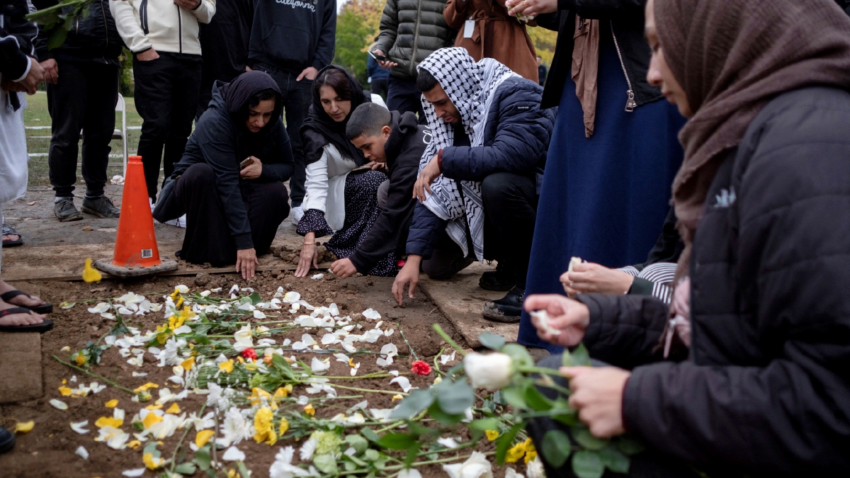 ORANG ramai menaburkan bunga di kubur Wadea Al-Fayoume di Perkuburan Parkholm Cemetery. FOTO REUTERS