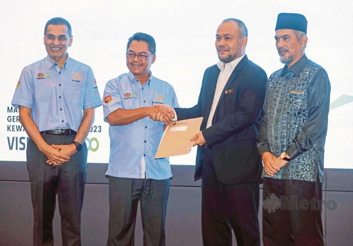 MUSTAPHA Sakmud (dua kiri) menyerahkan geran bantuan kewangan kepada penerima ketika Majlis Penyerahan Geran Bantuan Kewangan Perkeso kepada Institusi dan NGO 2023 di Putrajaya.  FOTO Mohd Fadli Hamzah