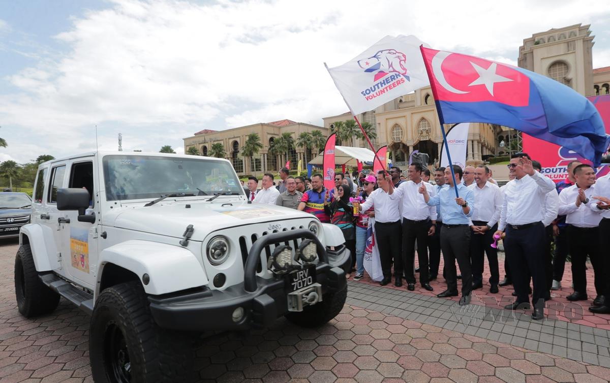 DATUK Onn Hafiz Ghazi mengibarkan bendera sebagai gimik Majlis Pelepasan Konvoi Southern Volunteers, Sukarelawan dan Agensi Kerajaan Pasca Banjir Negeri Johor . FOTO Nur Aisyah Mazalan