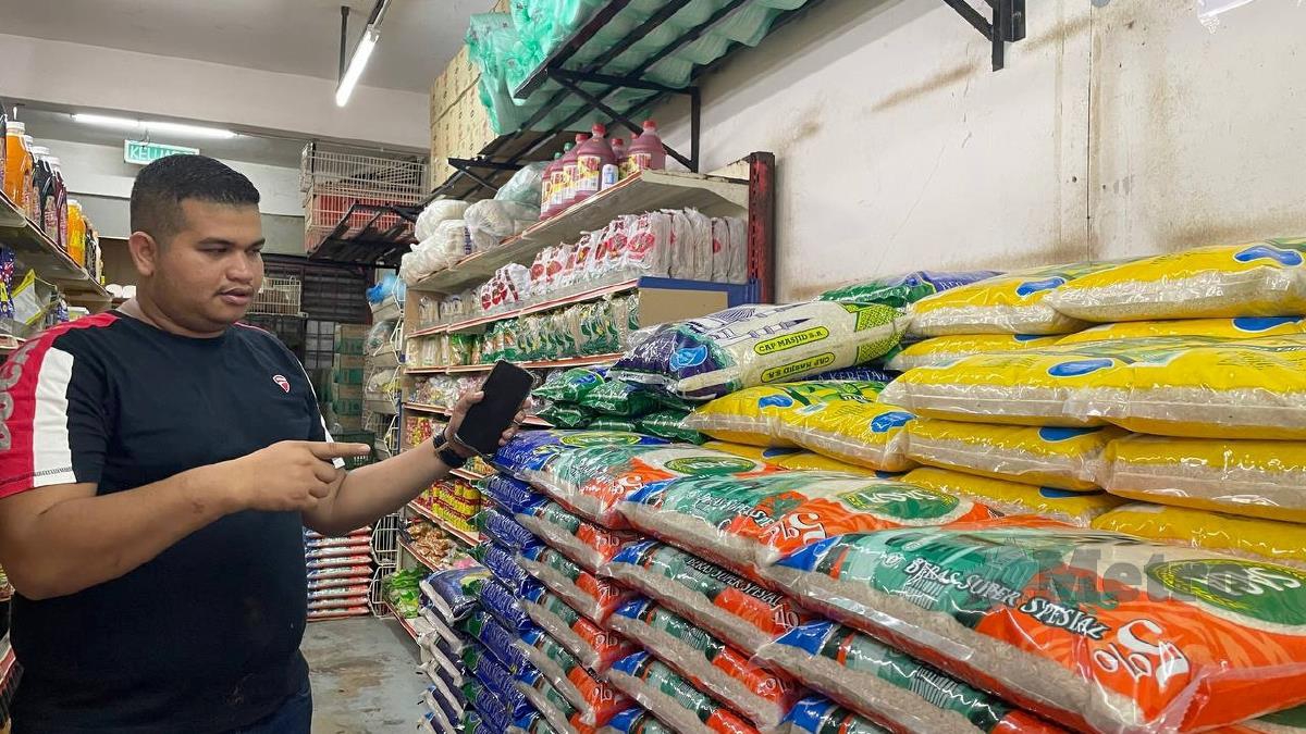 Muhammad Muhtadim menunjukkan beras import yang dijual di kedainya. FOTO Mohammad Khairil Ashraf Mohd Khalid