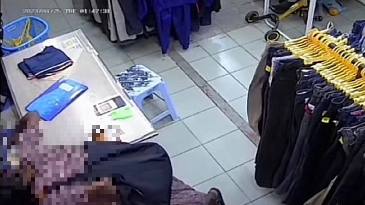 TANGKAP layar video tular yang memaparkan seorang wanita sedang mengambil wang di dalam laci wang di premis pakaian terpakai itu. FOTO TULAR