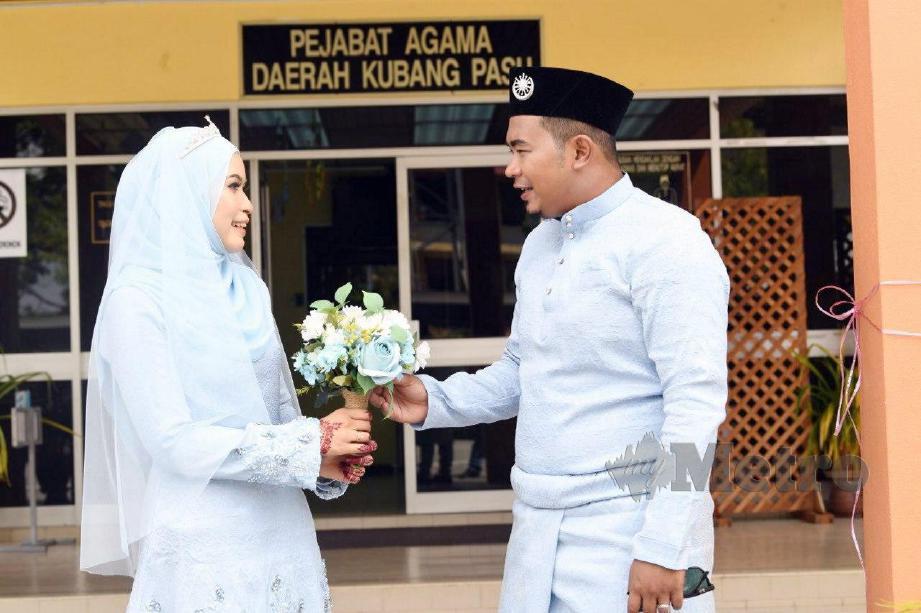 HANAFI bersama pasanganya, Siti Rohayu selepas dinikahkan di Pejabat Agama Daerah Kubang Pasu. FOTO Amran Hamid