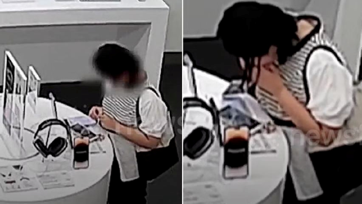 Wanita menggigit dan mengunyah wayar anti-kecurian bagi mencuri iPhone. FOTO NEWSFLARE