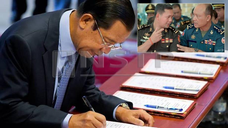 Hun Sen pertahan anaknya, Hun Manet (tengah) memegang jawatan kanan tentera. FOTO AFP 