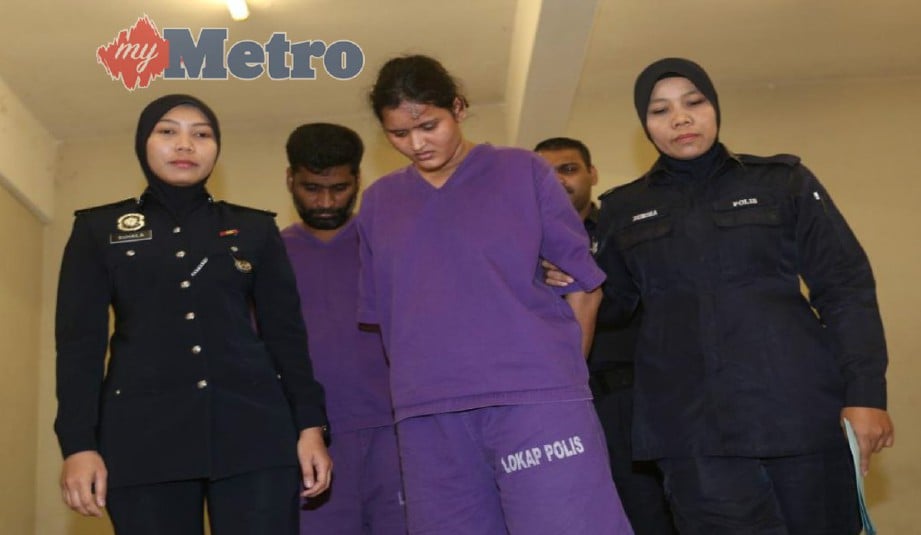 ANGGOTA polis mengiringi tertuduh yang didakwa memperdagangkan lima wanita warga India di Mahkamah Sesyen Seremban, hari ini. FOTO Hazreen Mohamad