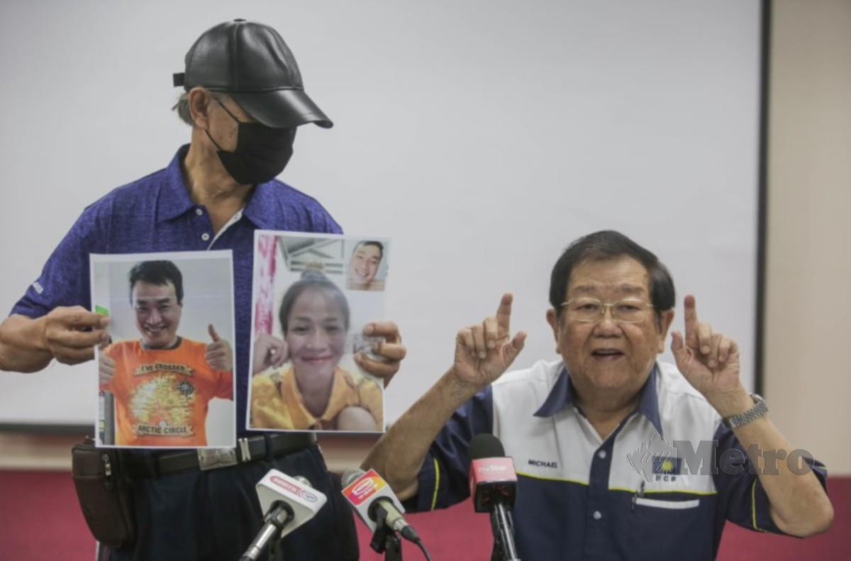 CHUA menunjukkan gambar anaknya Joshua Chua yang juga OKU pekak dan bisu didakwa menjadi mangsa Love scam. Turut kelihatan Michael Chong. FOTO Hazreen Mohamad. 