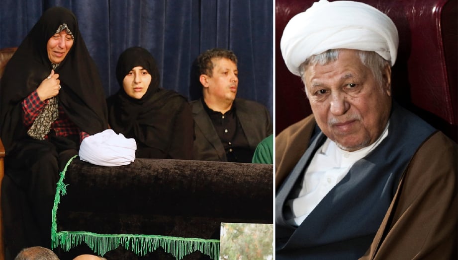 Dua anak Rafsanjani (gambar kanan), Mehdi Hashemi Rafsanjani (kanan) dan Fatemeh Hashemi Rafsanjani (kiri) duduk di tepi keranda bapa mereka di Masjid Jamaran, Teheran, hari ini. - Foto AFP