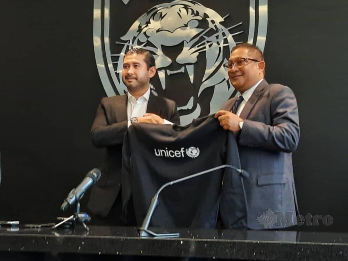 DR RASHEED (kanan) menyerah baju berimejkan logo UNICEF kepada Tunku Ismail (kiri) sebagai tanda simbolik kerjasama antara UNICEF dan JDT pada saingan Liga Malaysua (Liga M) musim depan. FOTO Rizar Mohd Noor.