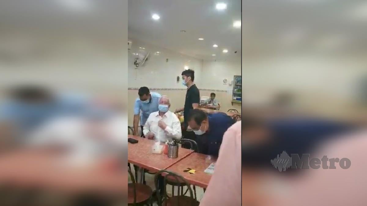 RAKAMAN video menunjukkan Najib masuk ke sebuah restoran tanpa melakukan imbasan suhu serta mendaftar MySejahtera. FOTO tular 