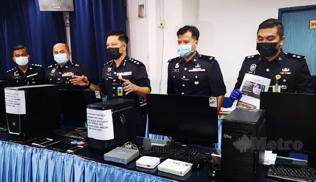 Ahsmon Bajah (tengah) menunjukkan peralatan perjudian dalam talian yang dirampas. FOTO MOHD ROJI KAWI
