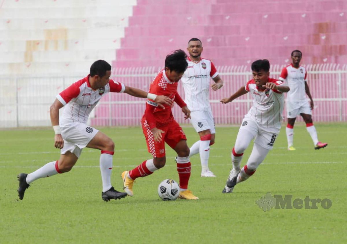 PEMAIN Kelantan FC, Nurshamel Abd Ghani (baju merah) diasak oleh pemain Sarawak United FC, pada perlawanan pertama Liga Perdana 2021 di Stadium Muhammad IV, Kota Bharu. FOTO Nik Abdullah Nik Omar