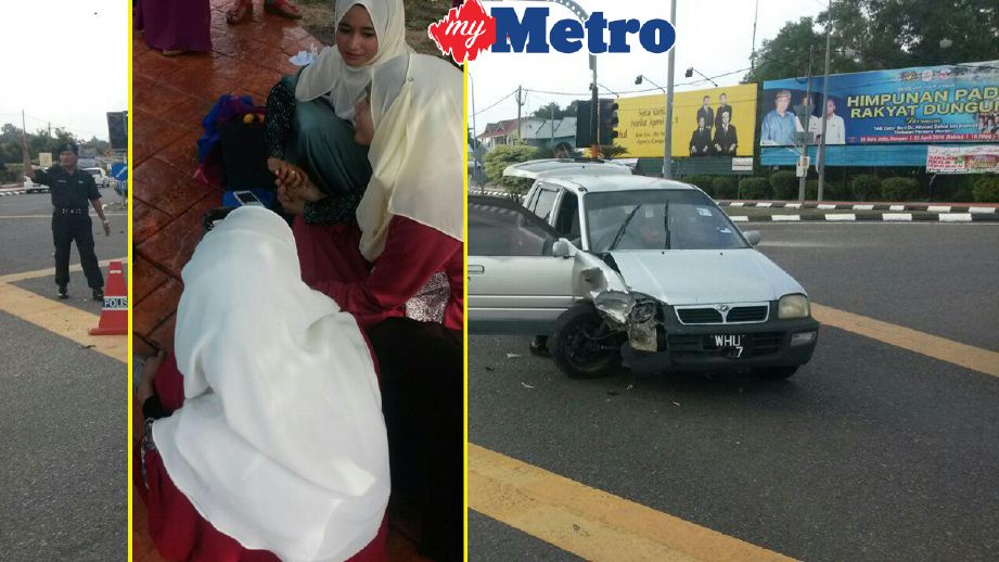 Atirah (tengah) ditenangkan orang ramai selepas kereta dipandu terbabit kemalangan. FOTO Rosli Ilham