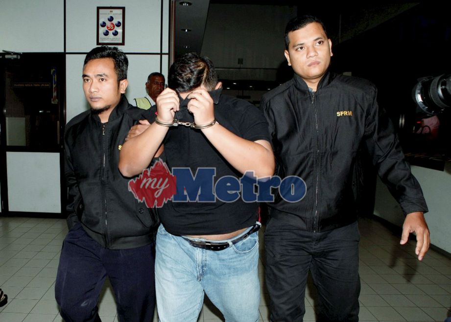Pegawai Suruhanjaya Pencegahan Rasuah Malaysia (SPRM) mengiringi Mohd Khairi ke Mahkamah Sesyen Butterworth atas tuduhan pengubahan wang haram. FOTO Amir Irsyad Omar