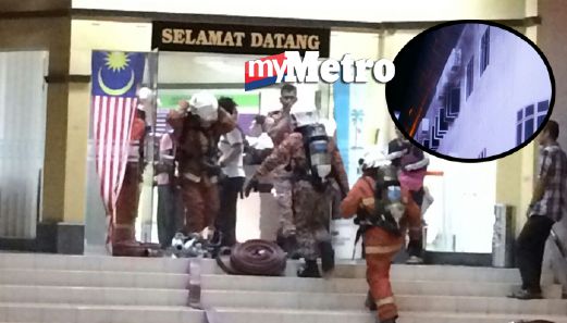 Anggota bomba di tempat kejadian. Kesan asap di tingkat dua (gambar kecil). FOTO Rudy Syareme Sheriffudin