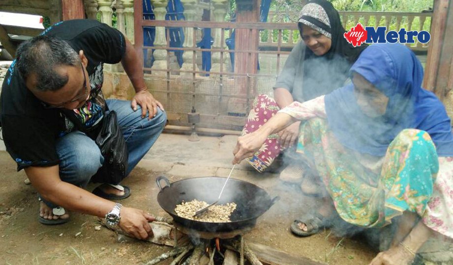 HALIMAH menggoreng biji kopi kampung secara tradisional. FOTO Safuri Kamarudin 