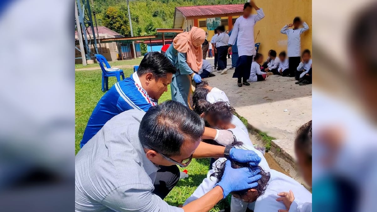 MOHD Halim dan guru-guru membantu membersihkan kepala murid yang berkutu. FOTO Mohd Halim Mohamad Zaid.