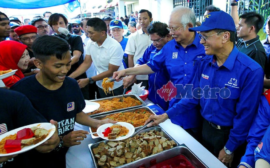 Najib bersama Raja Nong Chik menghidangkan makanan kepada masyarakat Taman Pantai Indah, Parlimen Lembah Pantai. FOTO Asyraf Hamzah 