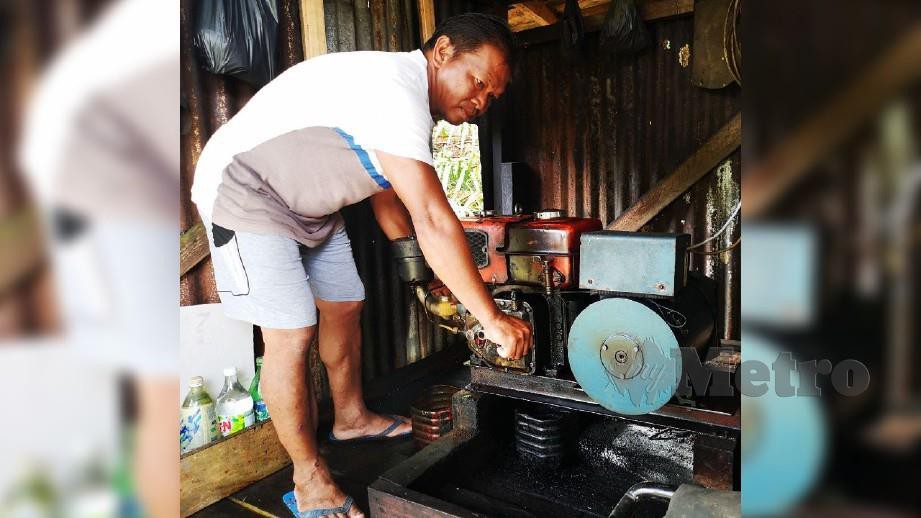 Sabri Ya, menghidupkan generator untuk membekalkan elektrik di rumahnya di Kampung Bungan Besar. FOTO MOHD ROJI KAWI