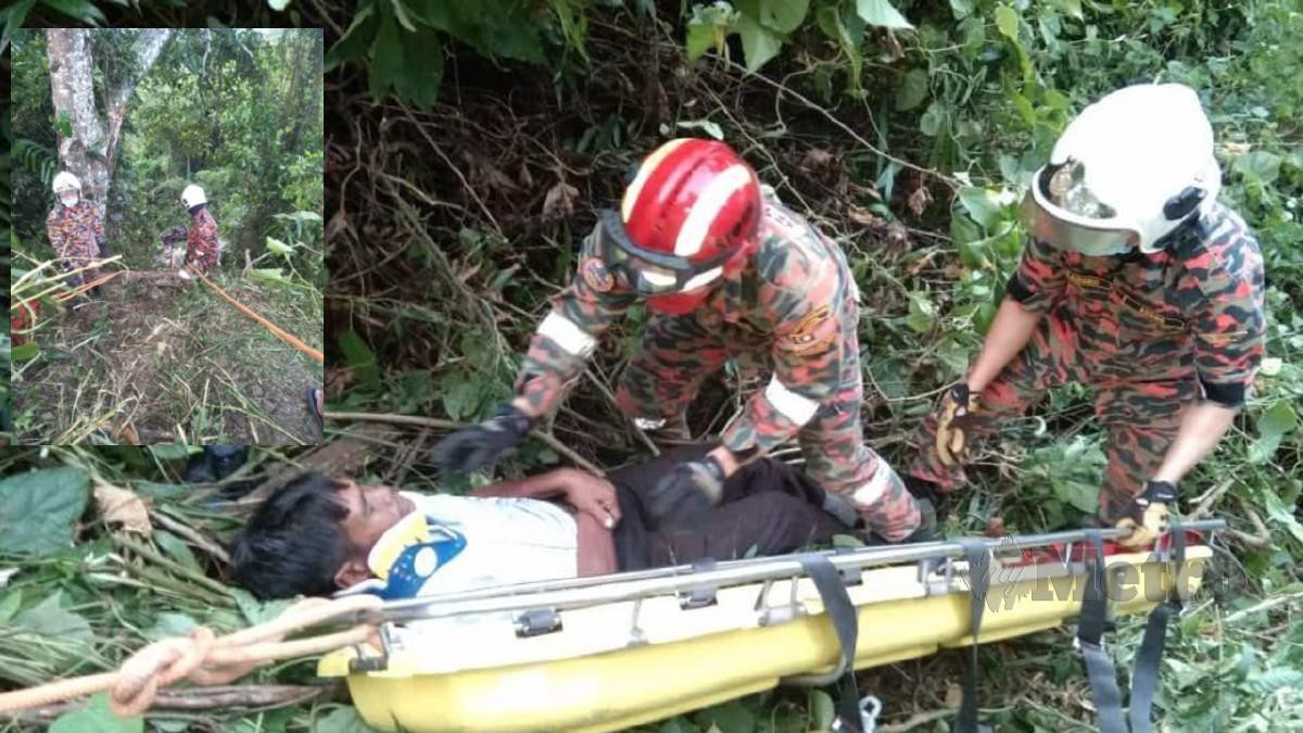 Mangsa dibantu anggota bomba selepas lorinya terjunam ke dalam gaung sedalam 70 meter di Kilometer 5 Jalan Kundasang-Ranau di sini, hari ini. (Gambar kecil) Anggota bomba menggunakan tali untuk turun ke lokasi.