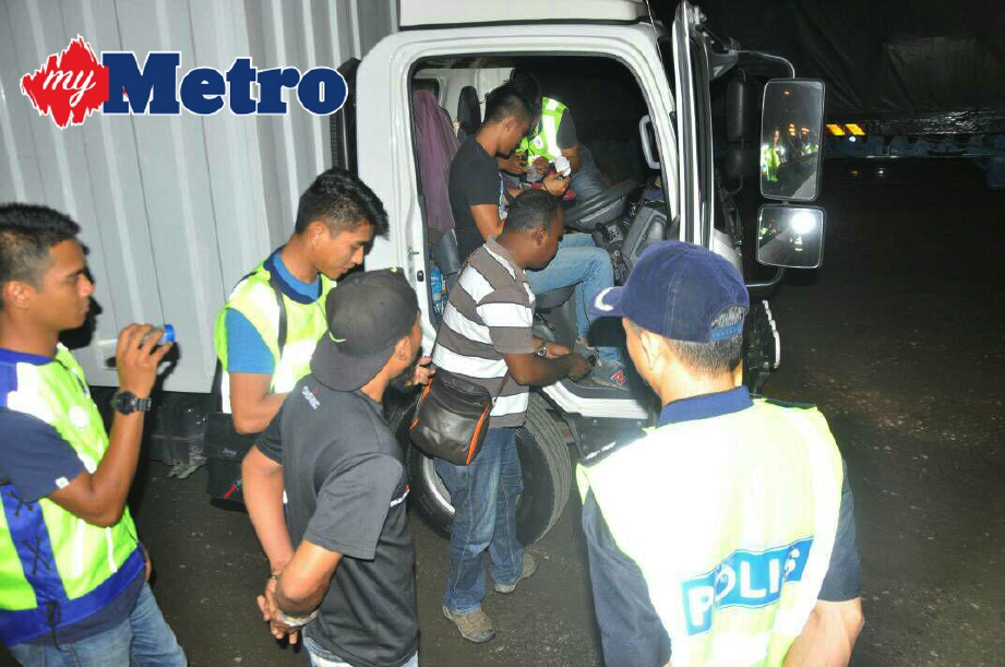Pihak berkuasa memeriksa salah seorang pemandu lori berikutan penemuan dadah. FOTO Shaiful Shahrin Ahmad Pauzi