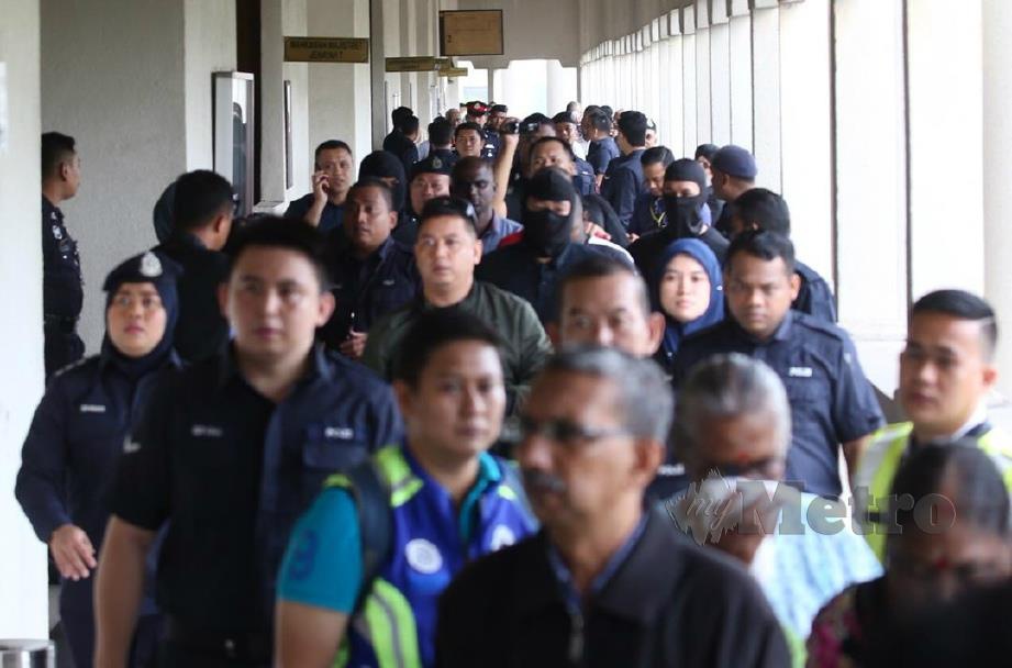 POLIS mengawal ketat tertuduh yang dibawa ke Mahkamag Sesyen Kuala Lumpur. FOTO Mohamad Shahril Badri Saali.
