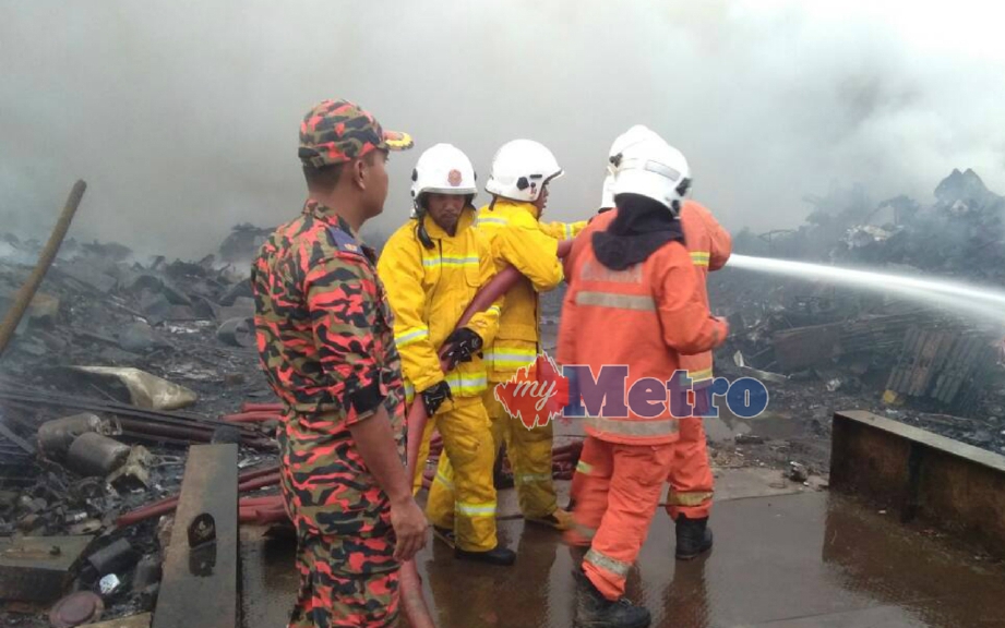 ANGGOTA bomba berusaha memadam kebakaran  premis Premis pengumpulan barangan lusuh di Pasir Tumboh, Kota Bharu, petang semalam. FOTO ihsan bomba 