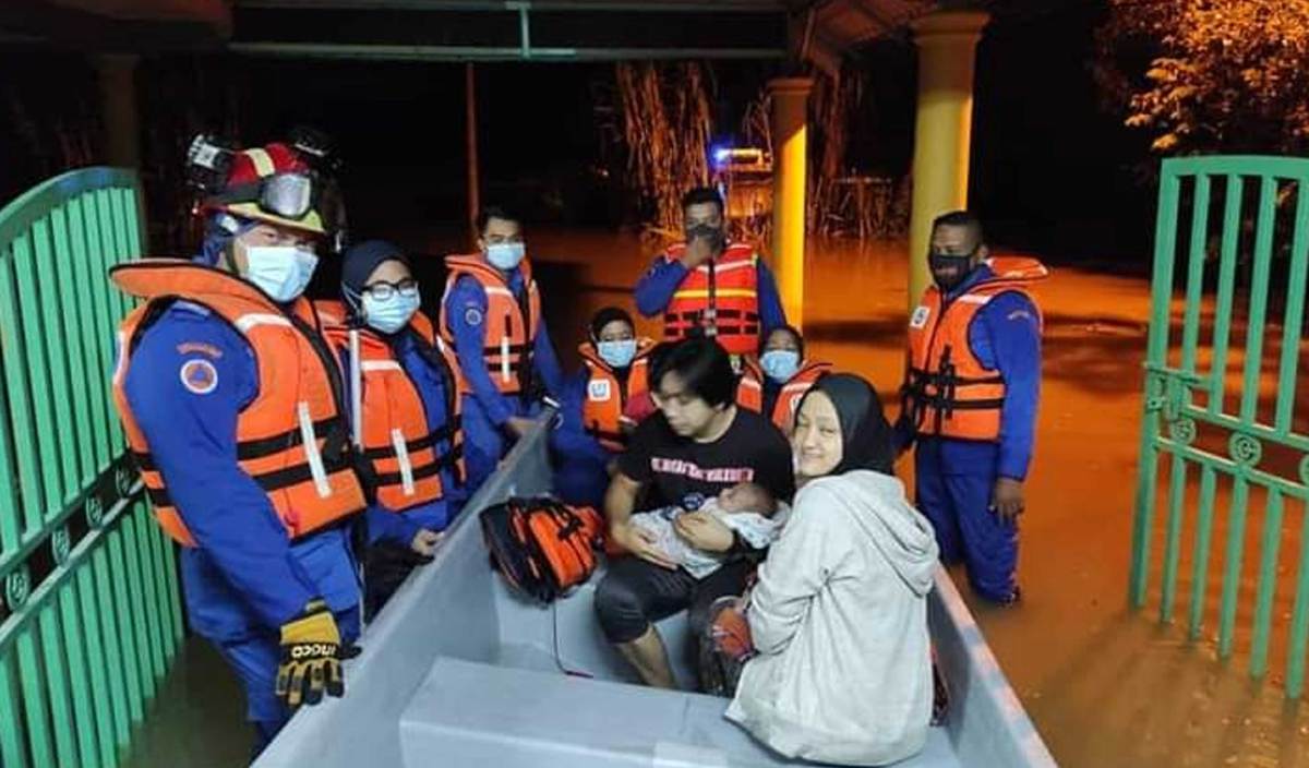 ANGGOTA Angkatan Pertahanan Awam Malaysia (APM) Daerah Kuala Selangor membawa keluar mangsa banjir dari kediaman masing-masing di Jalan Haji Ehsan, Kampung Parit Mahang. FOTO Ihsan APM Daerah Kuala Selangor