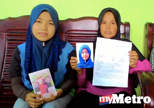  Maizun (kanan) dan anaknya, Nur Fazlina Zainol, 27, menunjukkan salinan laporan polis serta gambar Maisarah yang hilang sejak 22 September lalu. - Foto BERNAMA (Fail).