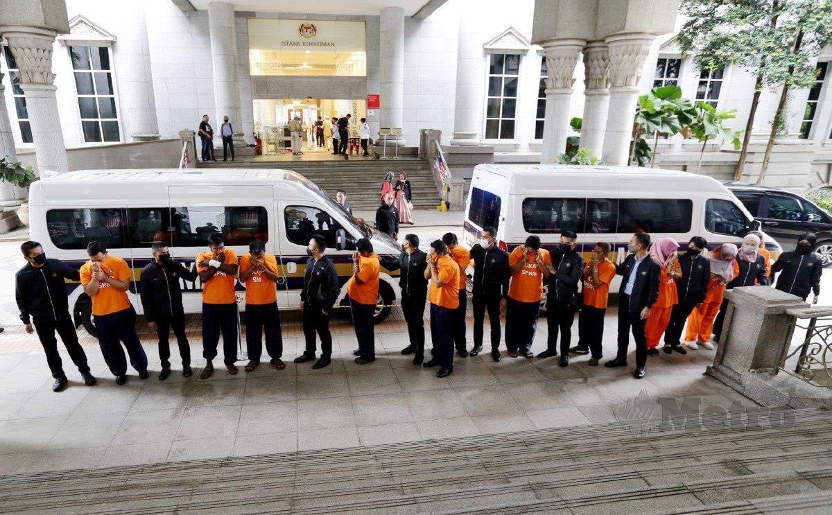 PEGAWAI SPRM membawa suspek untuk direman berkaitan kes penyeludupan warga asing di Mahkamah Putrajaya. FOTO Mohd Fadli Hamzah