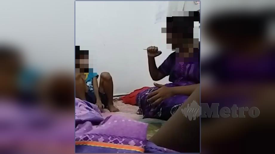 Rakaman yang tular di media sosial memaparkan wanita memarahi kanak-kanak perempuan sambil memegang objek tajam di tangan. FOTO Tular