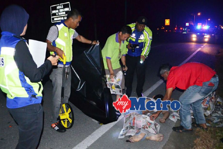 Anggota polis memeriksa mayat mangsa yang maut selepas motosikalnya terbabit dalam kemalangan dengan sebuah kereta di Kilometer 4, Jalan Kampung Koh-Ayer Tawar dekat Sitiawan, malam tadi. FOTO ihsan Miss Miko